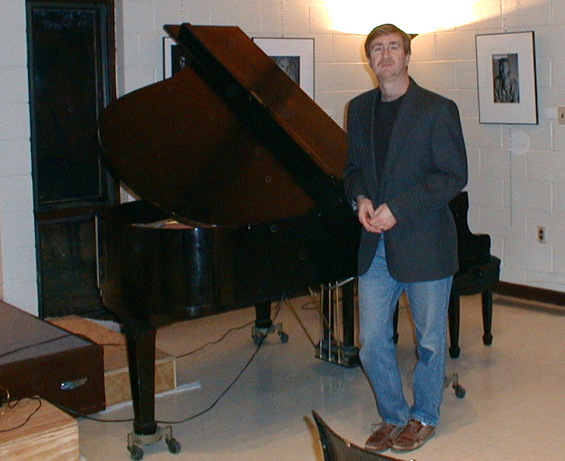 Brian standing next to piano